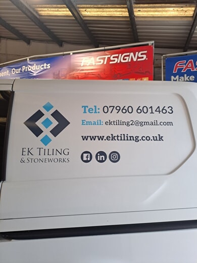An image of the side of the van with the vehicle graphics showing the telephone number, email, and URL for EK Tiling
